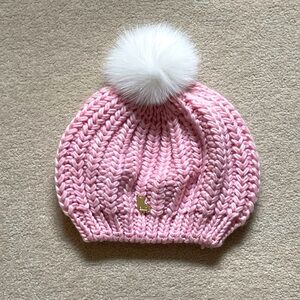 Pink chunky knit toque with white fur pom pom